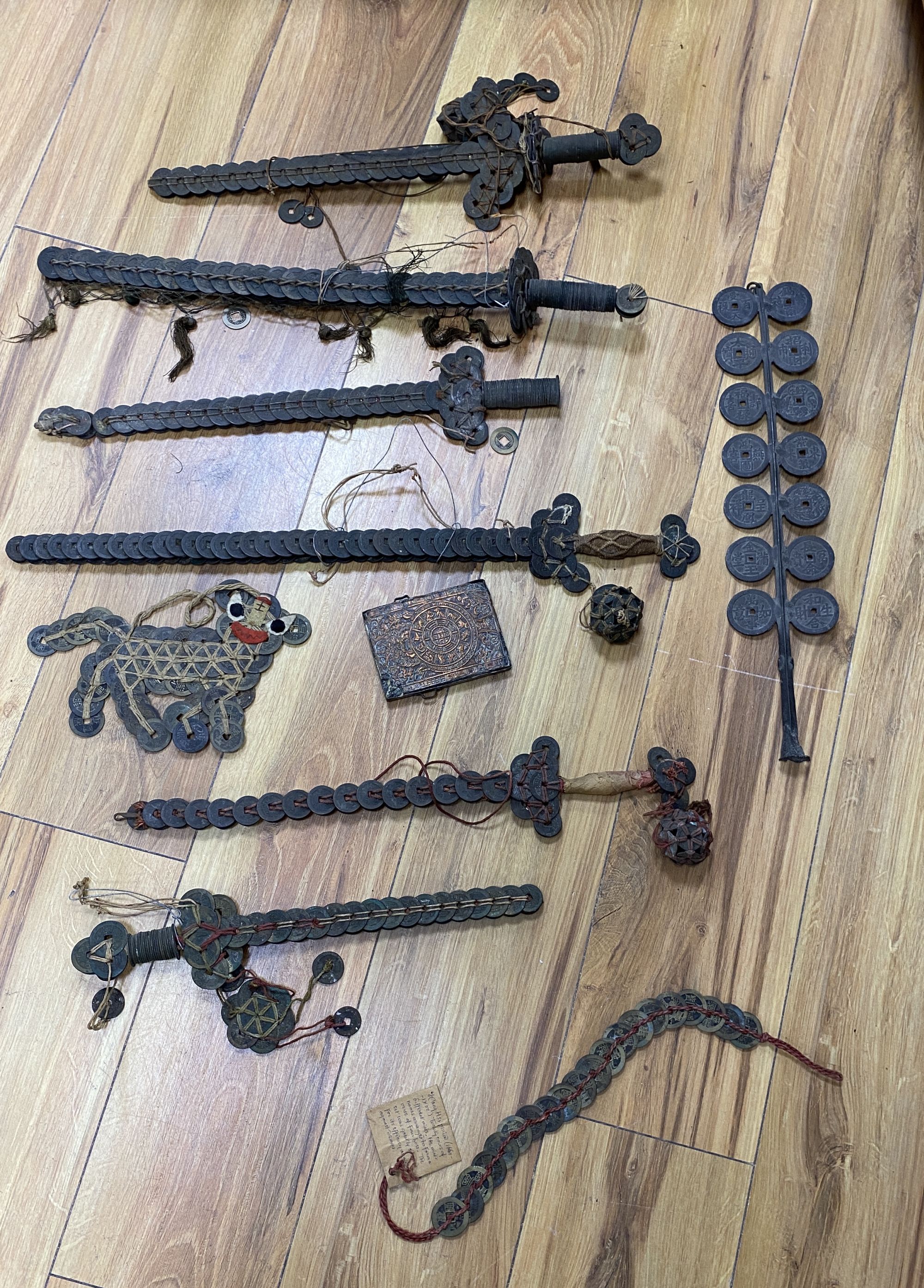 A group of Chinese coin swords and talismans,